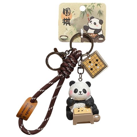 Go-playing panda keychain charm with traditional refined arts design on white background