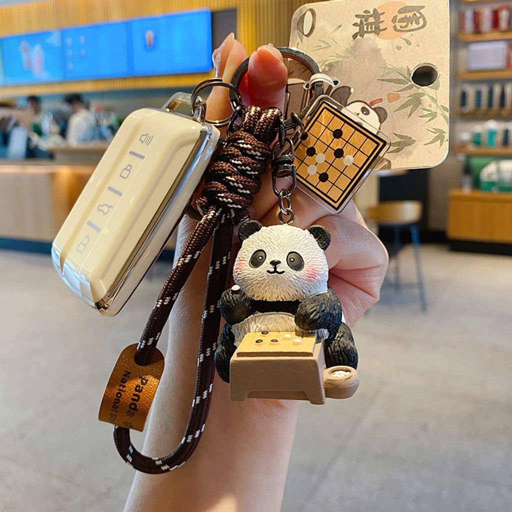 Go-playing panda keychain charm with traditional refined arts design attached to a car key fob