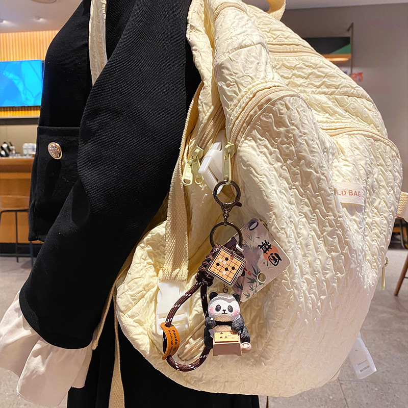 Go-playing panda keychain charm with traditional refined arts design hanging on a bag