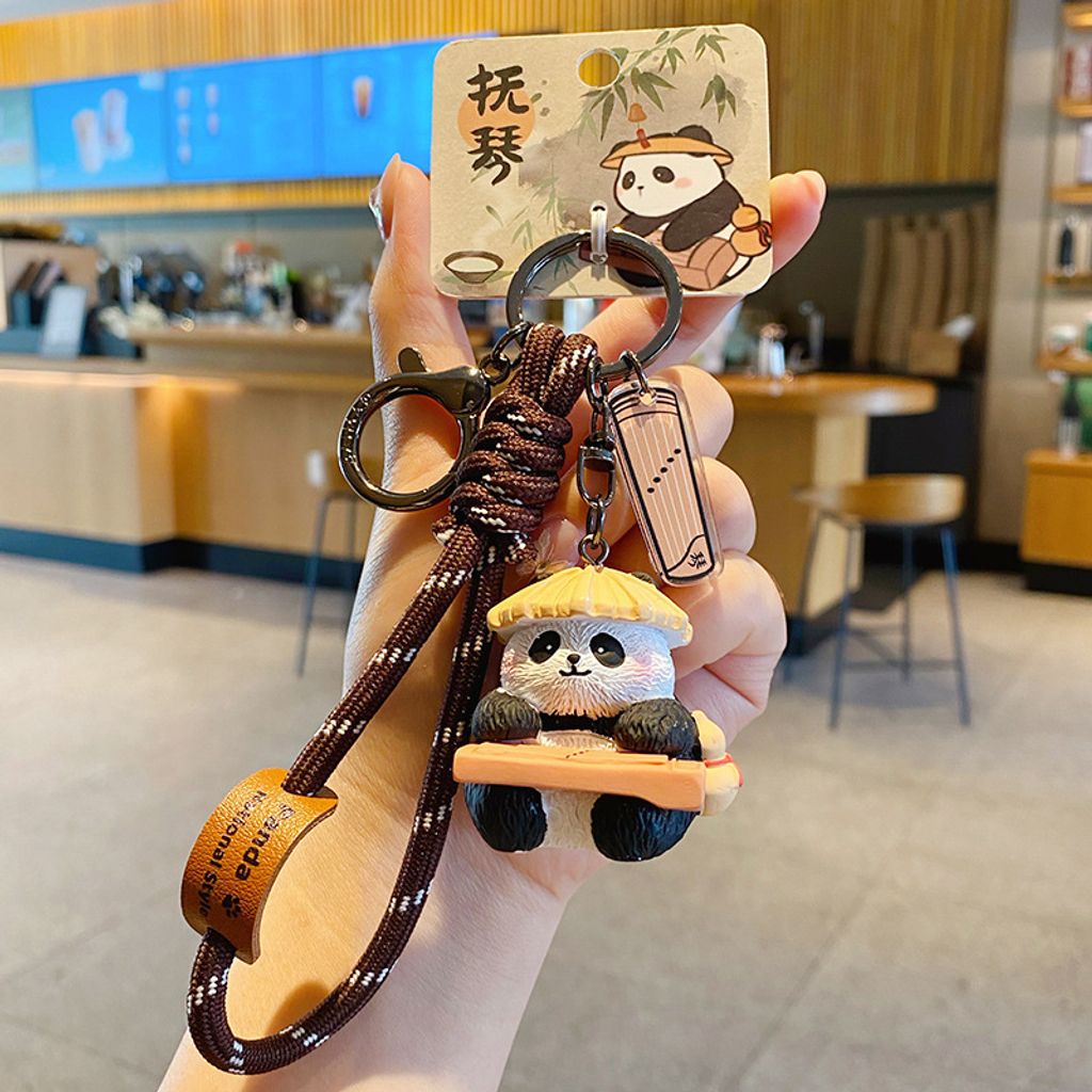 Guqin-playing panda keychain charm with traditional refined arts design