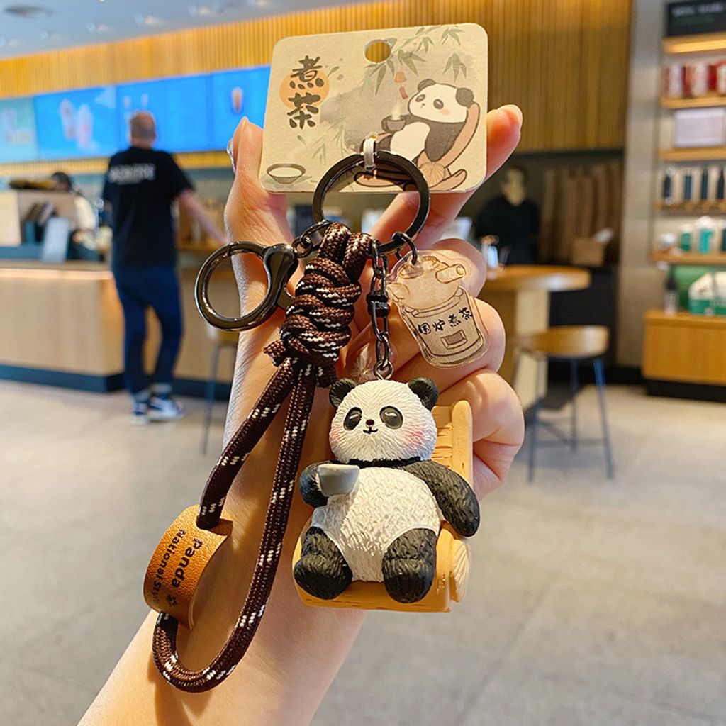 Tea-brewing panda keychain charm with traditional refined arts design