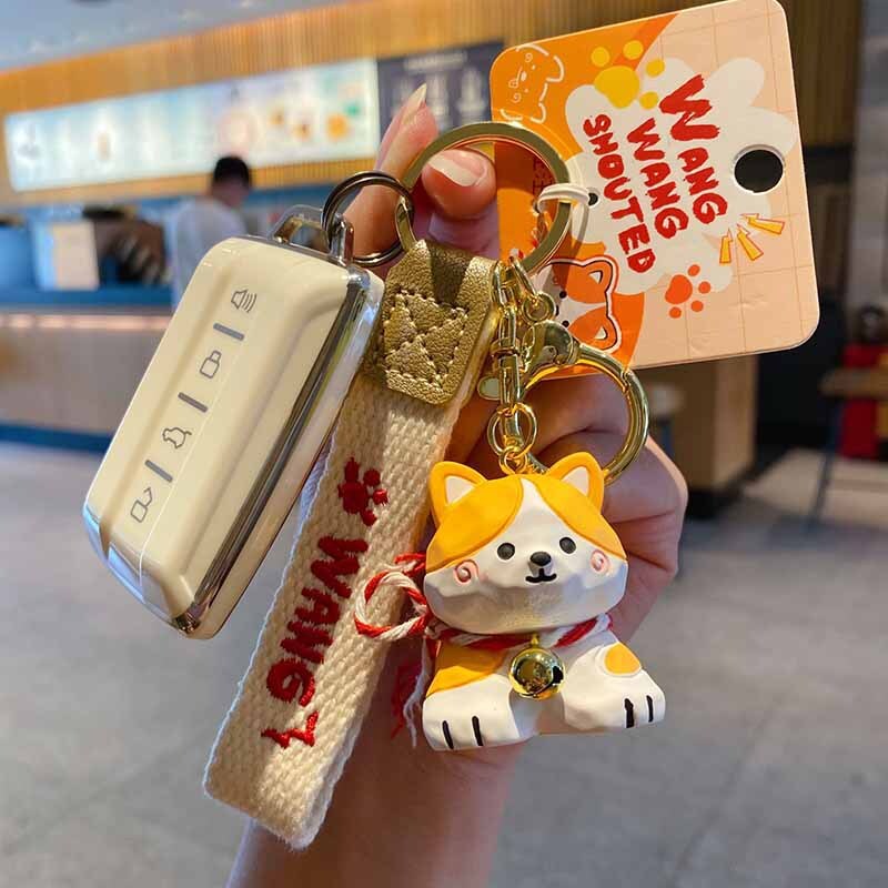 Corgi keychain charm in wood carving style attached to a car key fob