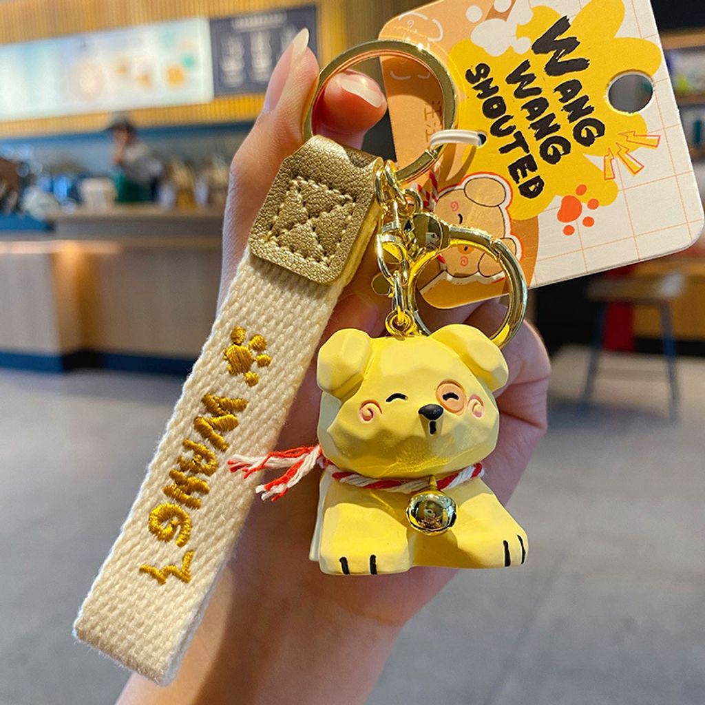 Yellow puppy keychain charm in wood carving style
