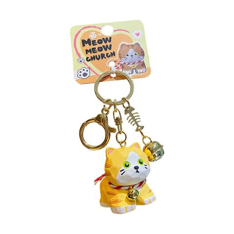 Orange tabby cat keychain charm on white background