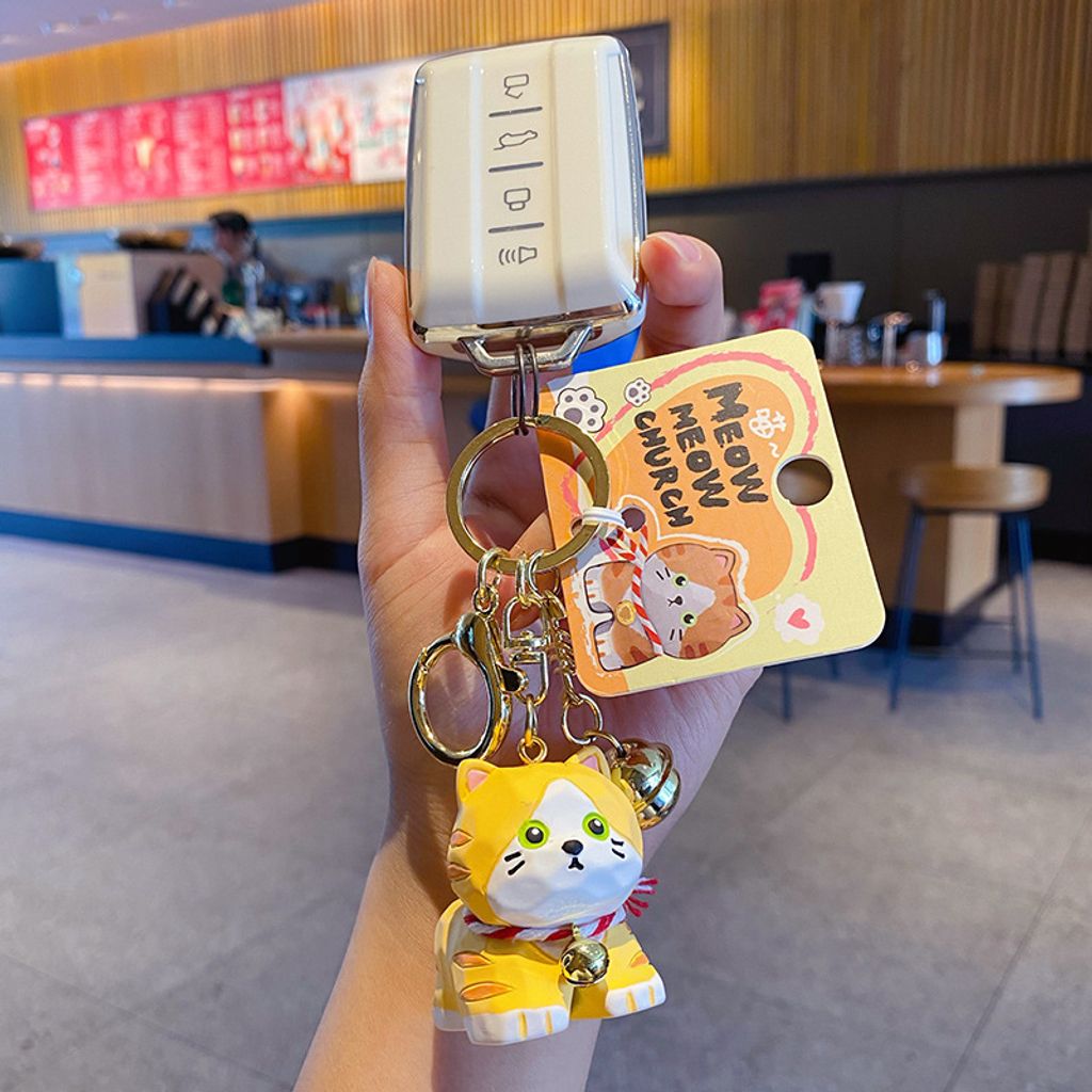 Orange tabby cat keychain charm attached to a car key fob