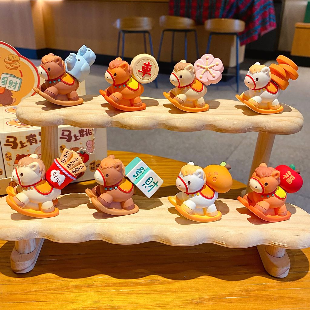 All eight designs of the wish-granting rocking horse mini figurines