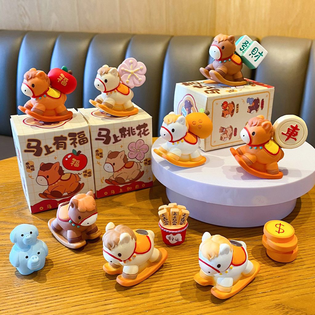 Eight wish-granting rocking horse mini figurines displayed together, with some magnetic accessories removed and placed beside them