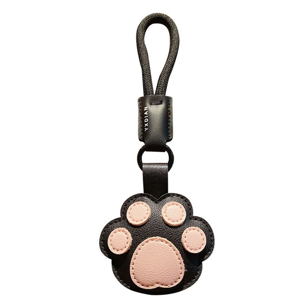 Cute paw leather keychain charm on white background
