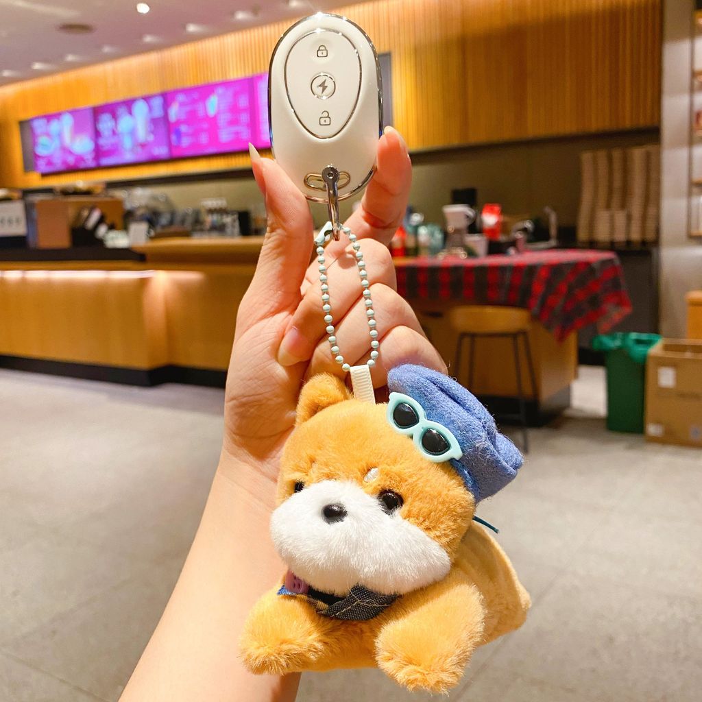 Shiba Inu puppy plush keychain charm with a kawaii dog design attached to a car key fob