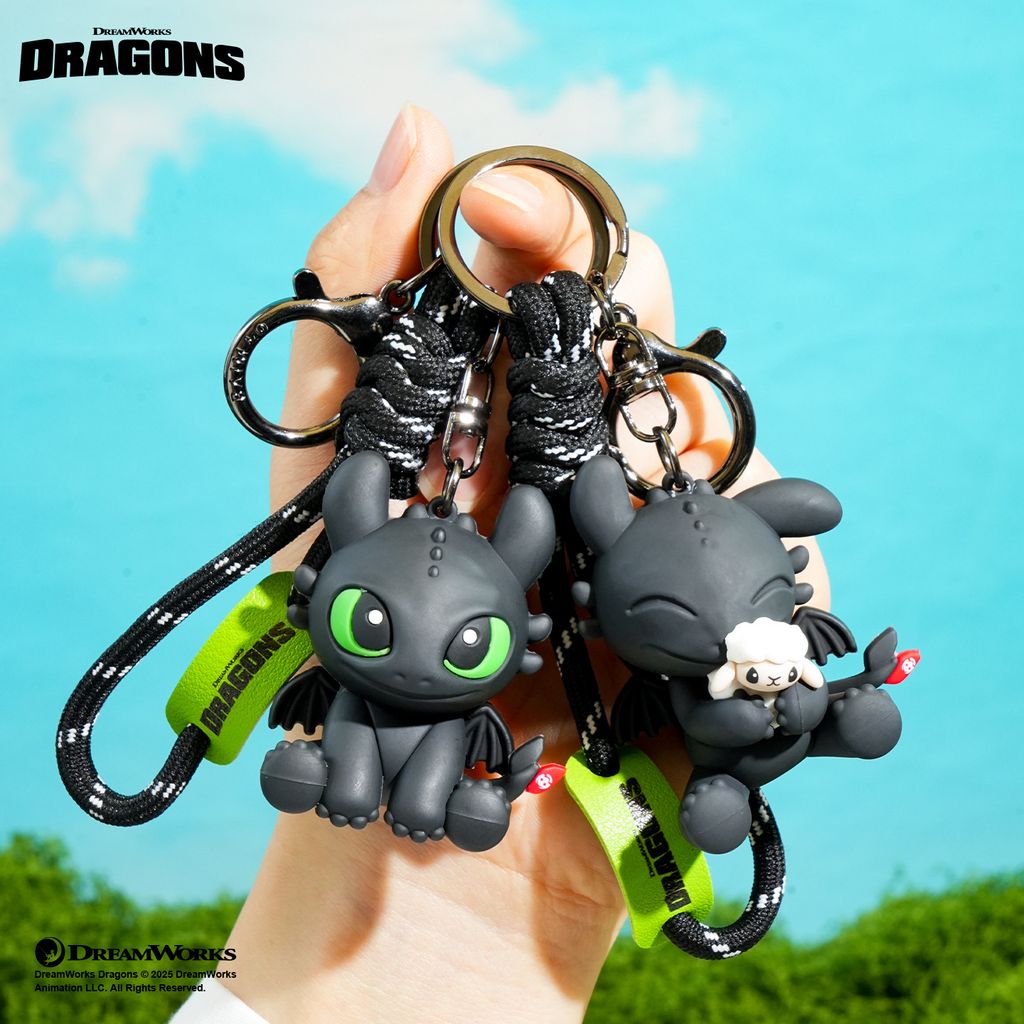 Sitting Toothless and Toothless with sheep 3D keychain charms displayed together