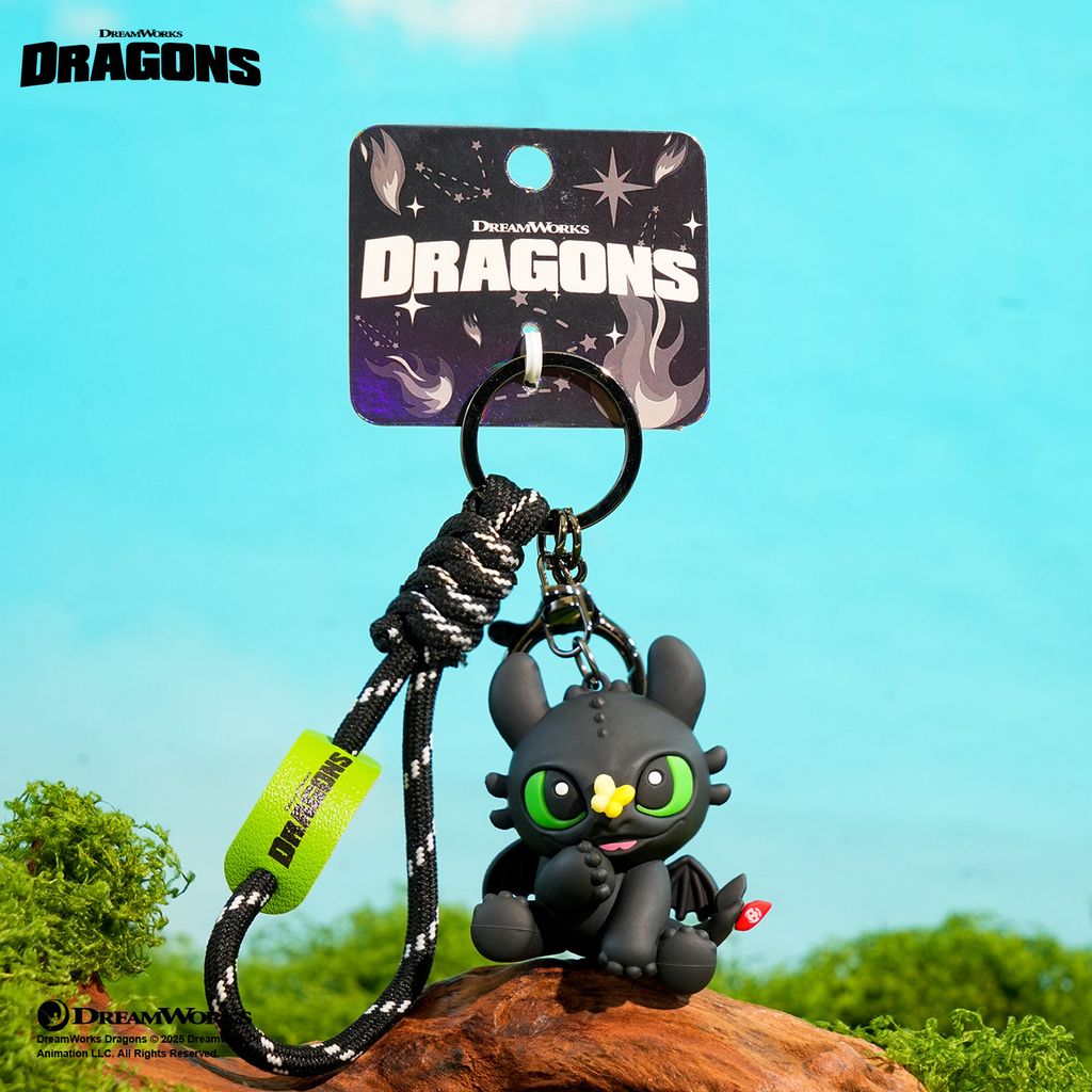 Toothless with butterfly 3D keychain charm showing Toothless interacting with a small butterfly