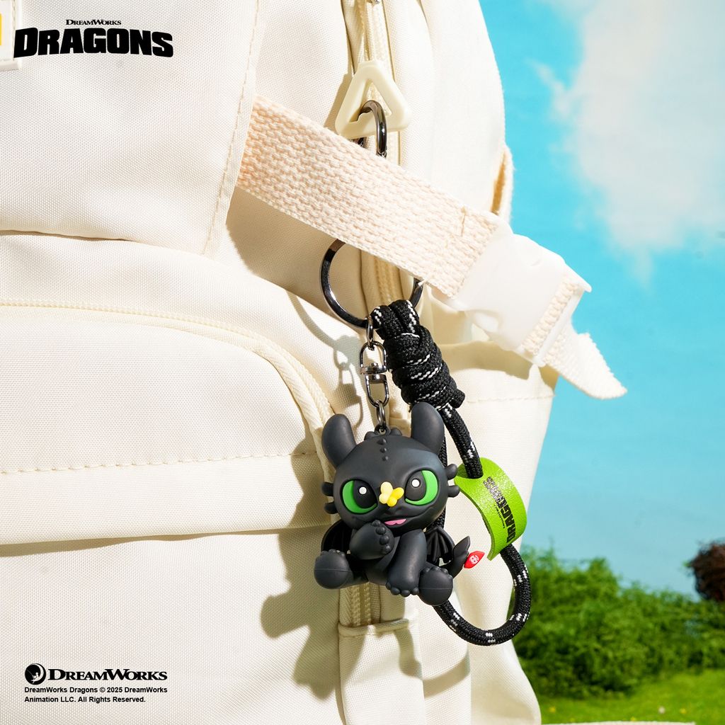 Toothless with butterfly 3D keychain charm hanging on a bag