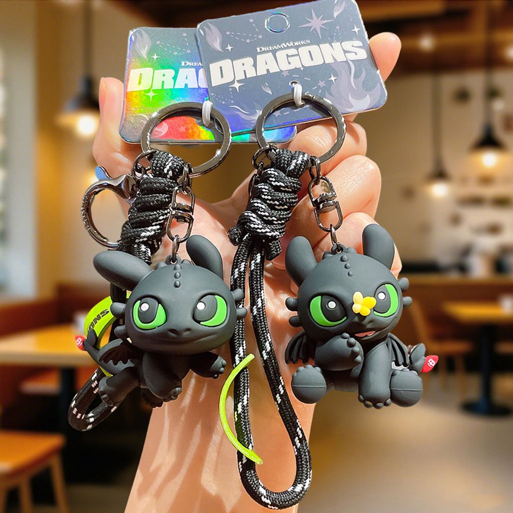 Flying Toothless and Toothless with butterfly 3D keychain charms displayed together
