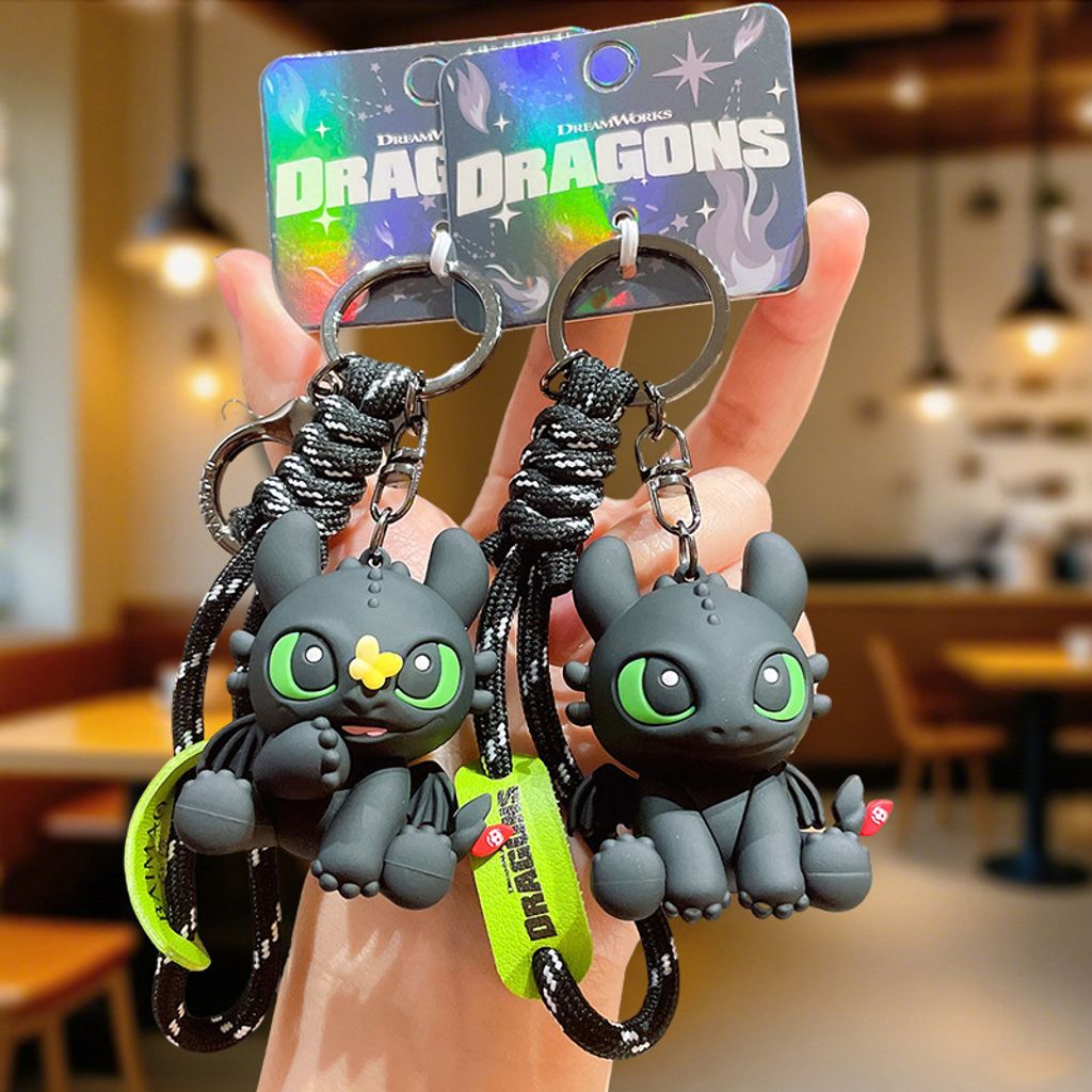 Toothless with butterfly and sitting Toothless 3D keychain charms displayed together