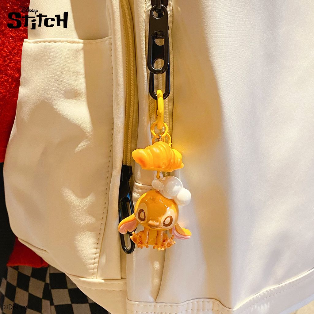 Stitch bakery keychain charm hanging on a bag