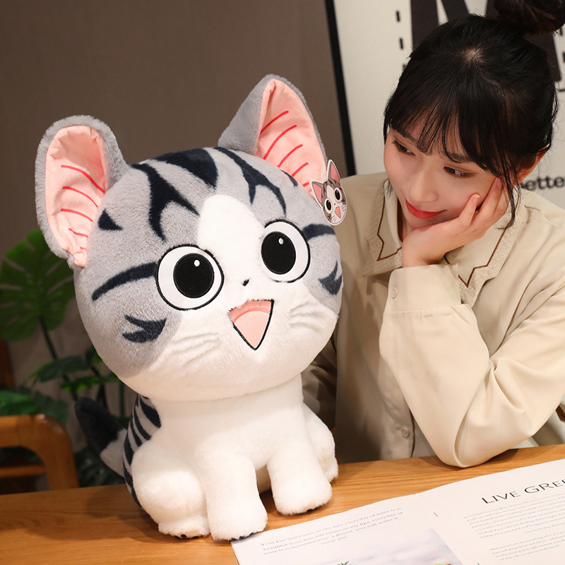 Chi’s Sweet Adventure cat plush toy for hugging and lounging on a table