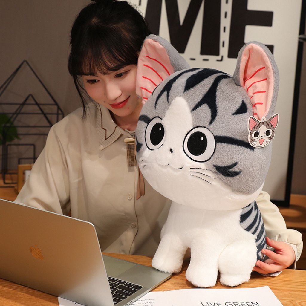 Chi’s Sweet Adventure cat plush toy for hugging and lounging on a table