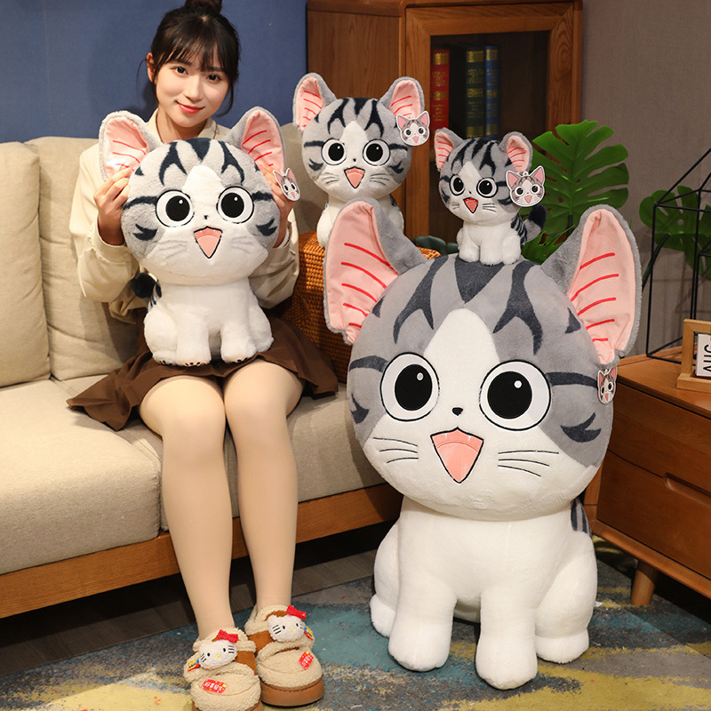 Chi’s Sweet Adventure cat plush toy for hugging and lounging on a sofa