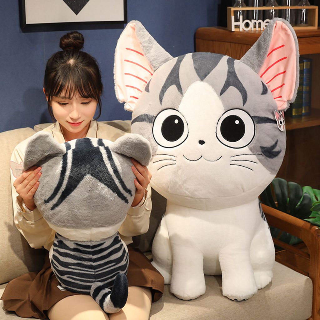 Chi’s Sweet Adventure cat plush toy for hugging and lounging on a sofa