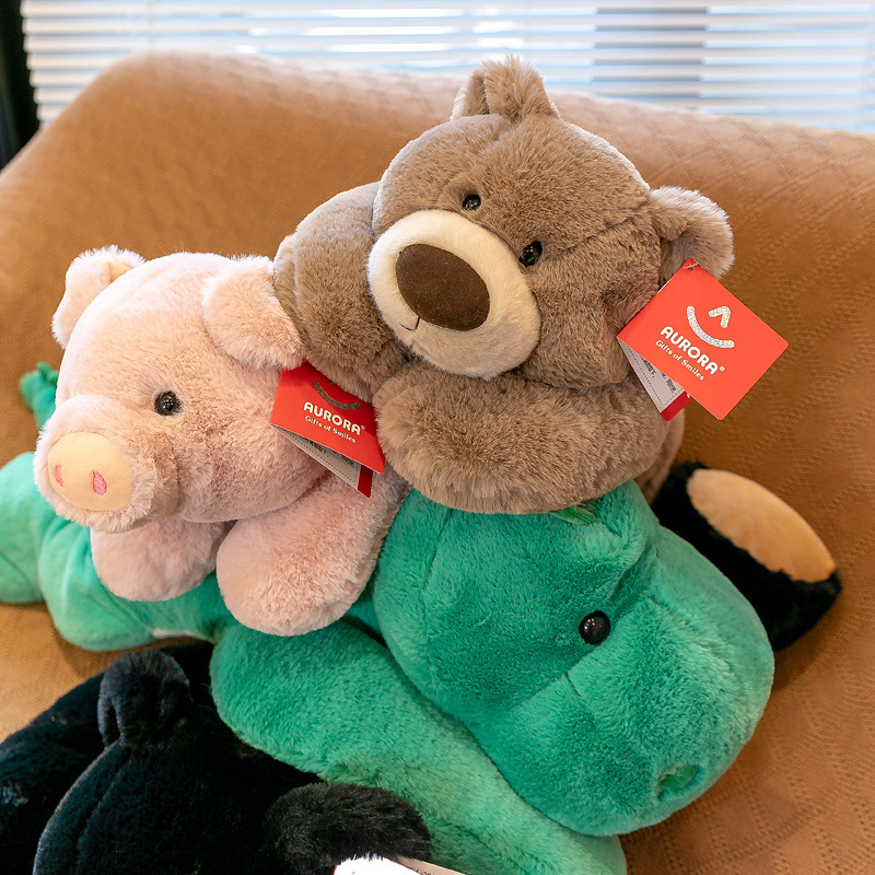 Lying plush toys stacked together on a sofa