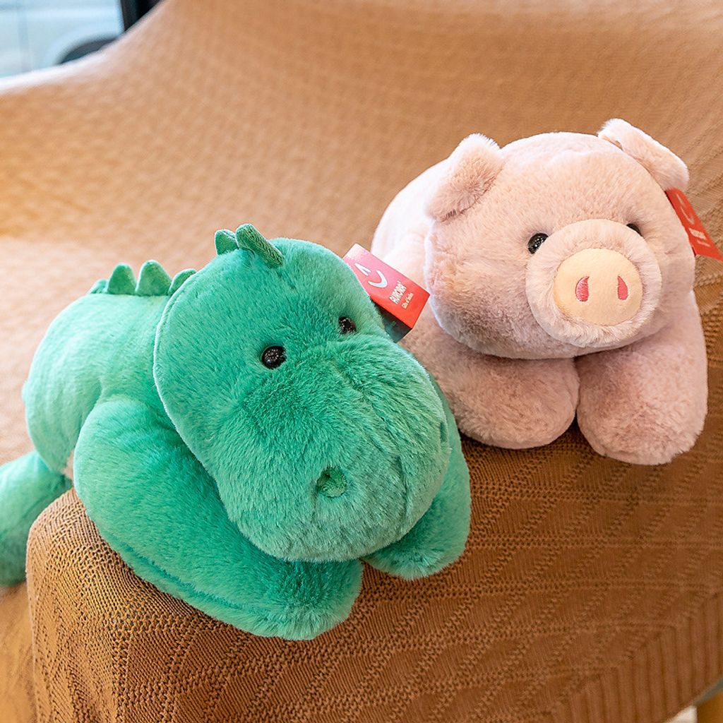 Animal lying plush toys placed together on a sofa