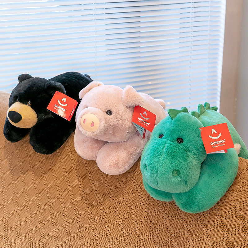 Lying plush toys displayed together on a sofa