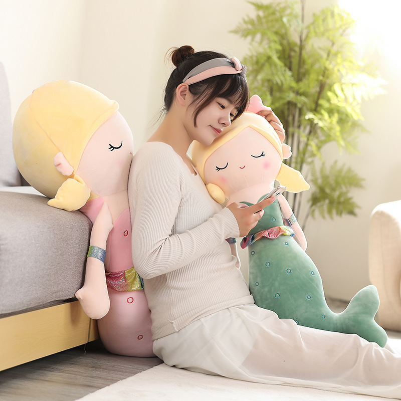 Cute mermaid plush toy used as a cozy body pillow while lounging