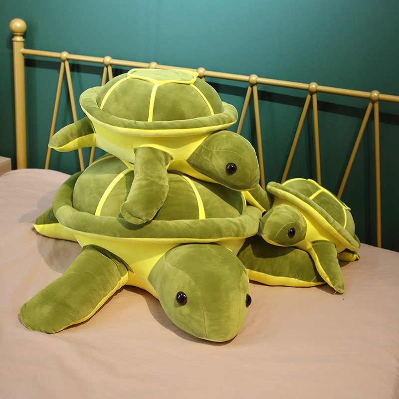 Giant turtle plush pillow stacked to show size differences