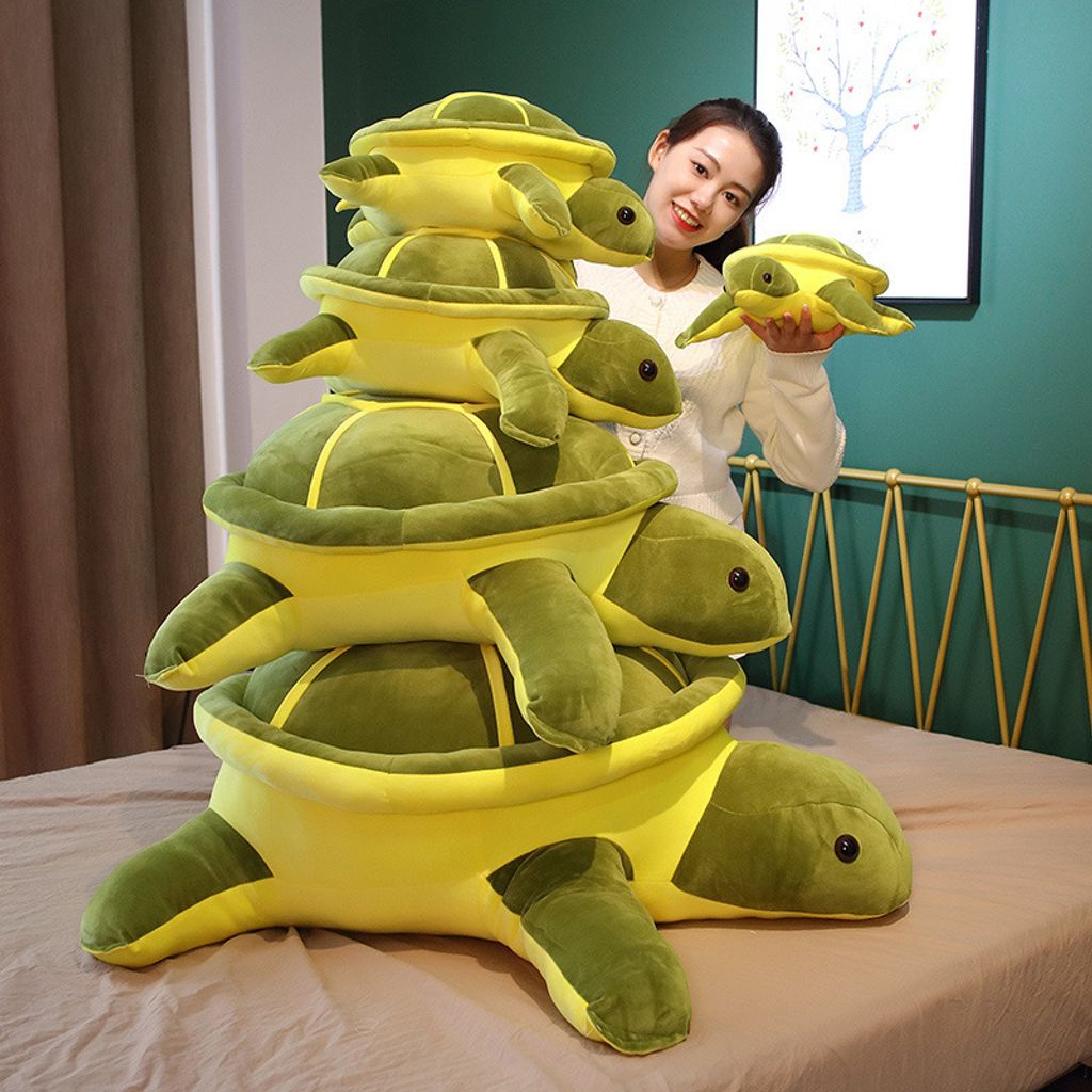 Giant turtle plush pillow shown in five sizes
