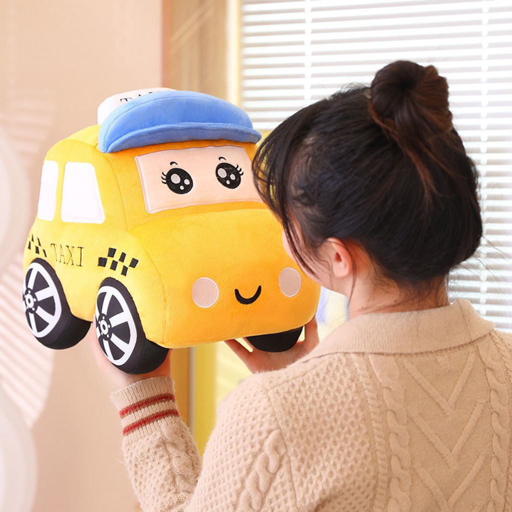 Cartoon taxi plush toy held for hugging
