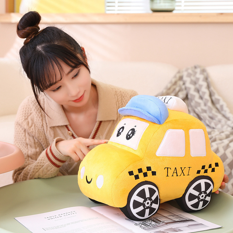 Cartoon taxi plush toy displayed on table
