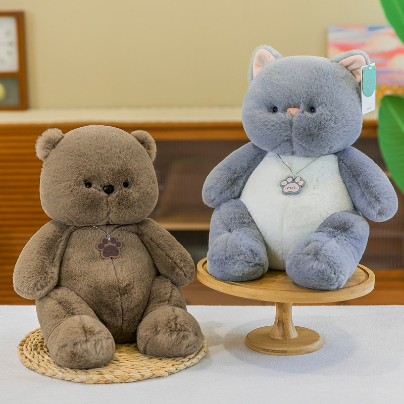 Brown bear and gray cat plush toys displayed side by side