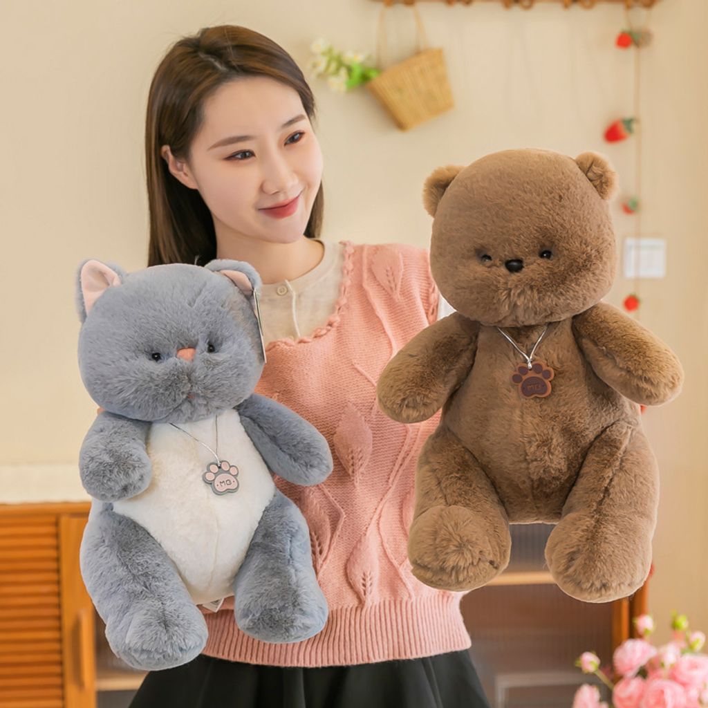 Gray cat and brown bear plush toys displayed side by side