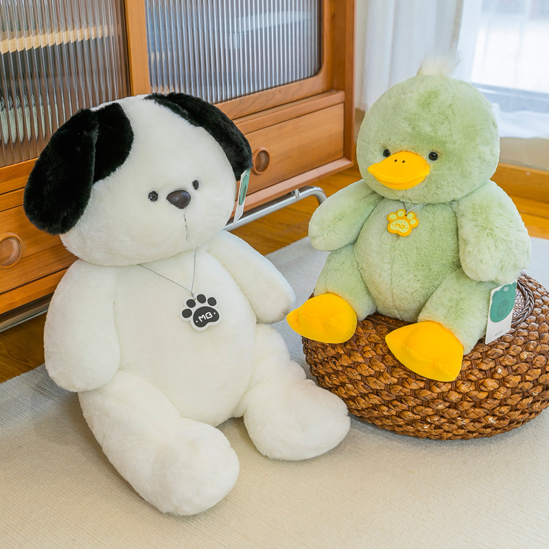 White dog and green duck plush toys displayed together in a home setting