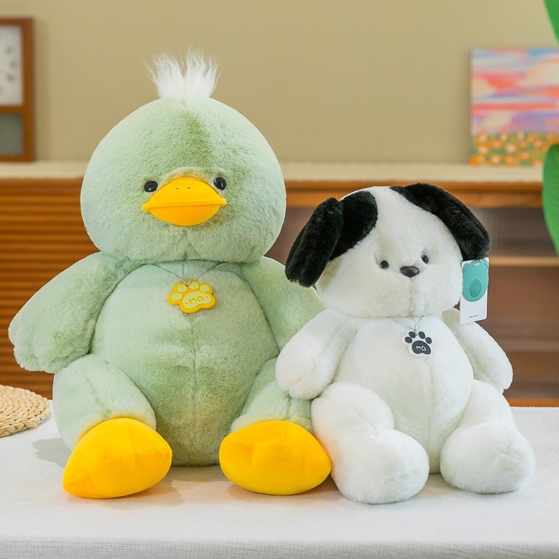 Green duck and white dog plush toys displayed side by side