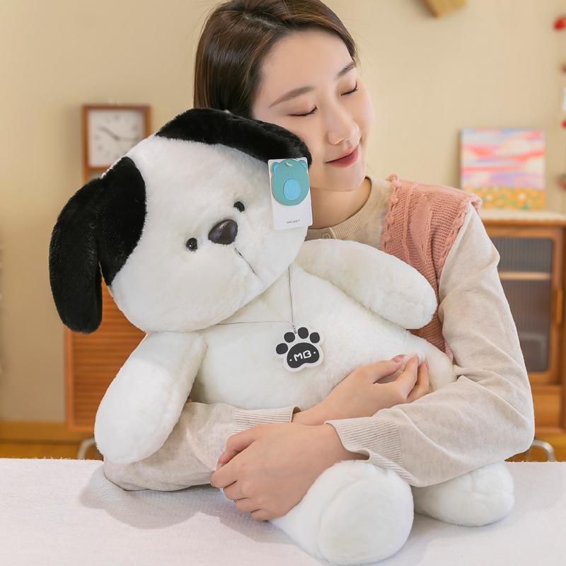 White dog plush toy hugged in arms showing soft and cuddly design