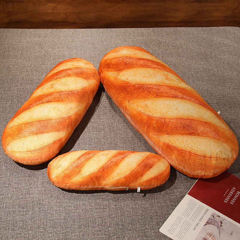 Realistic bread plush pillow shown in multiple sizes