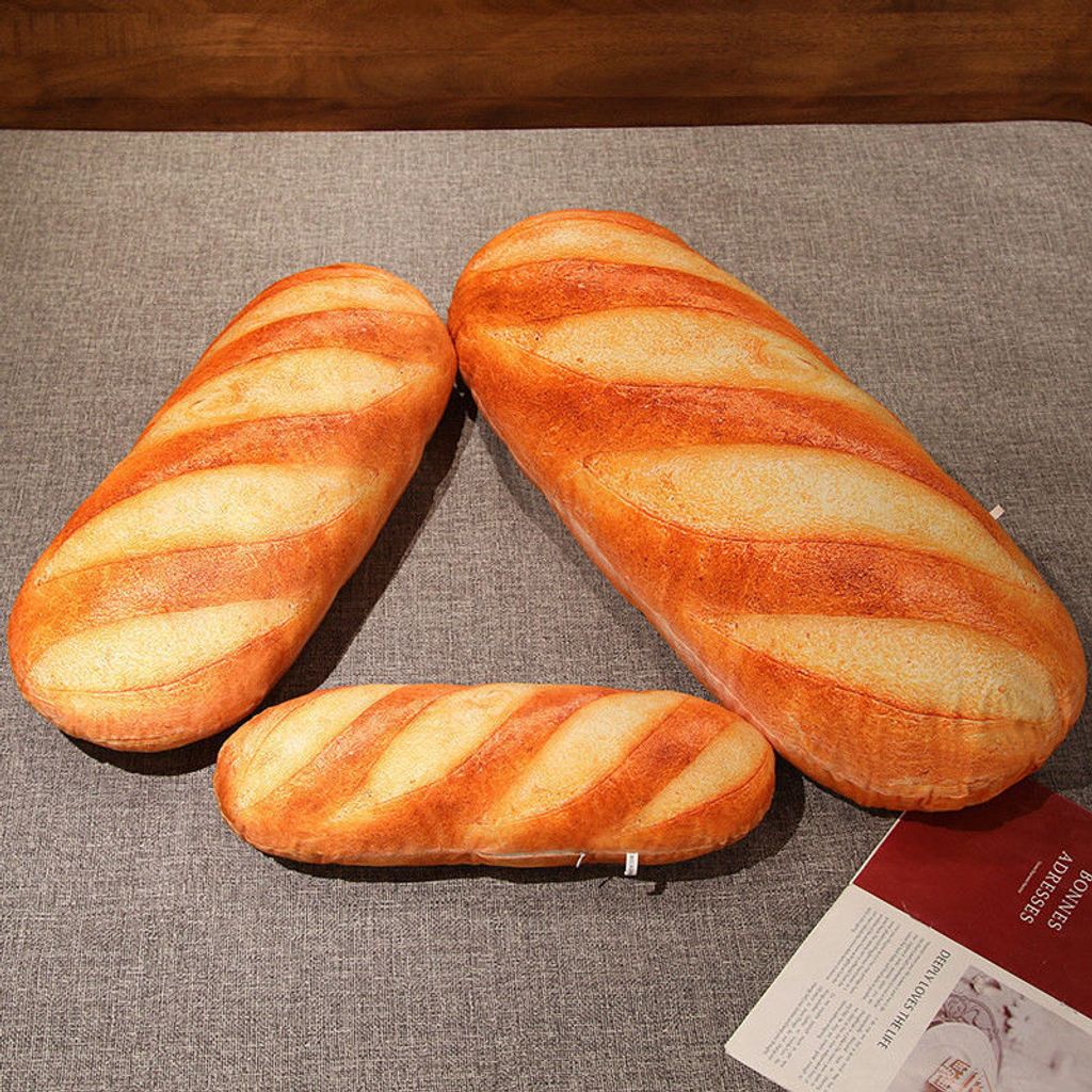 Realistic bread plush pillow shown in multiple sizes