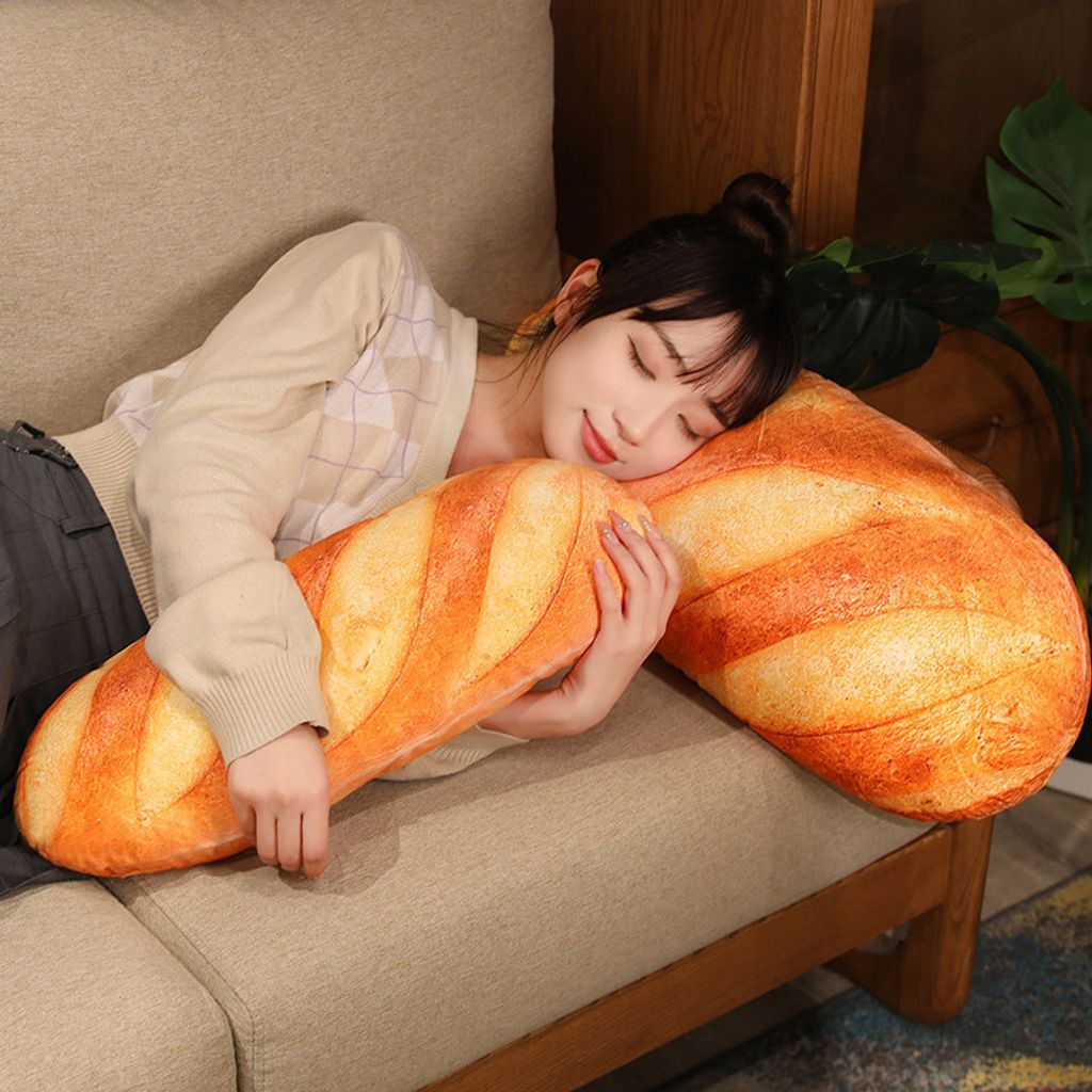 Realistic bread plush pillow used as a hugging pillow on sofa