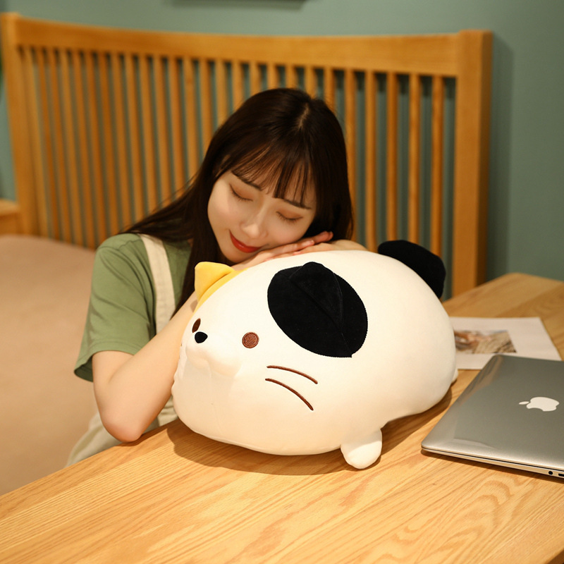 Cute round cat plush toy used as a cozy pillow for relaxing and napping