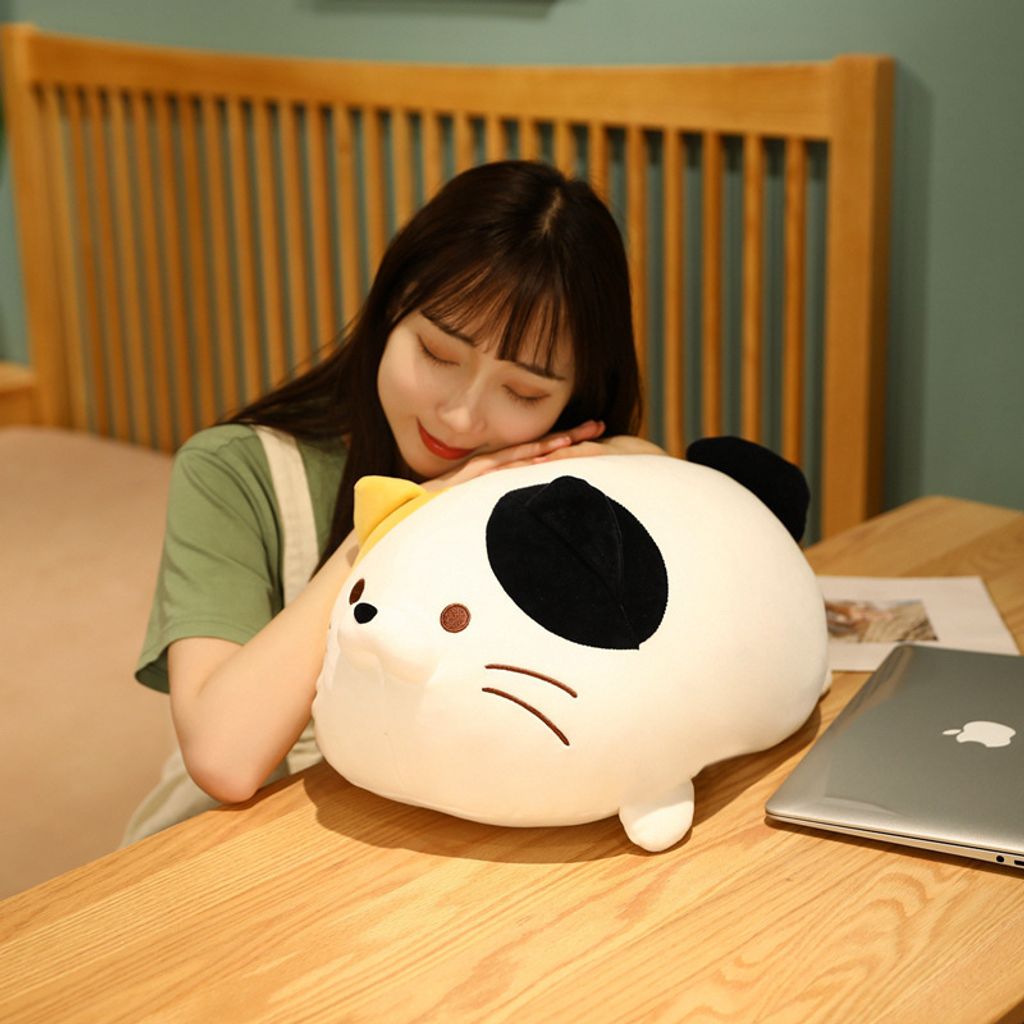 Cute round cat plush toy used as a cozy pillow for relaxing and napping