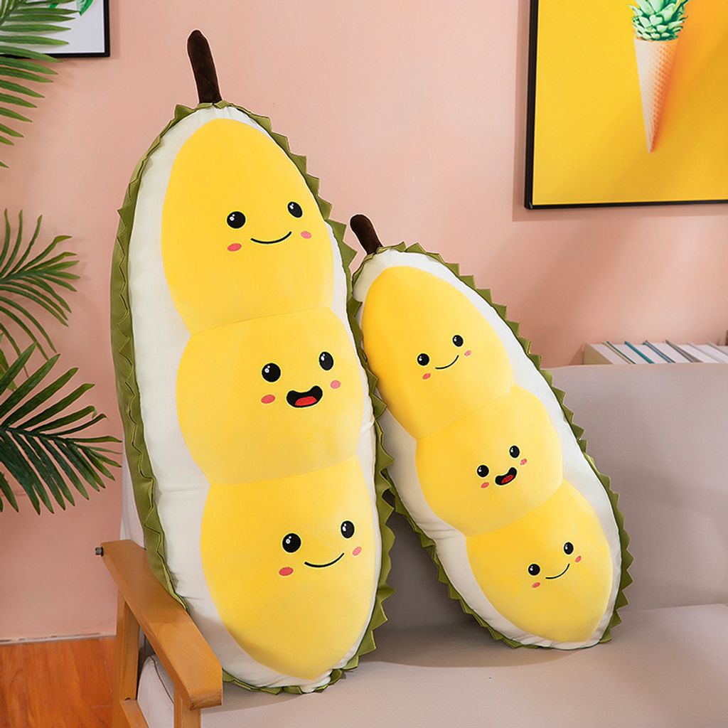 Cute durian plush pillow shown in different sizes leaning on sofa