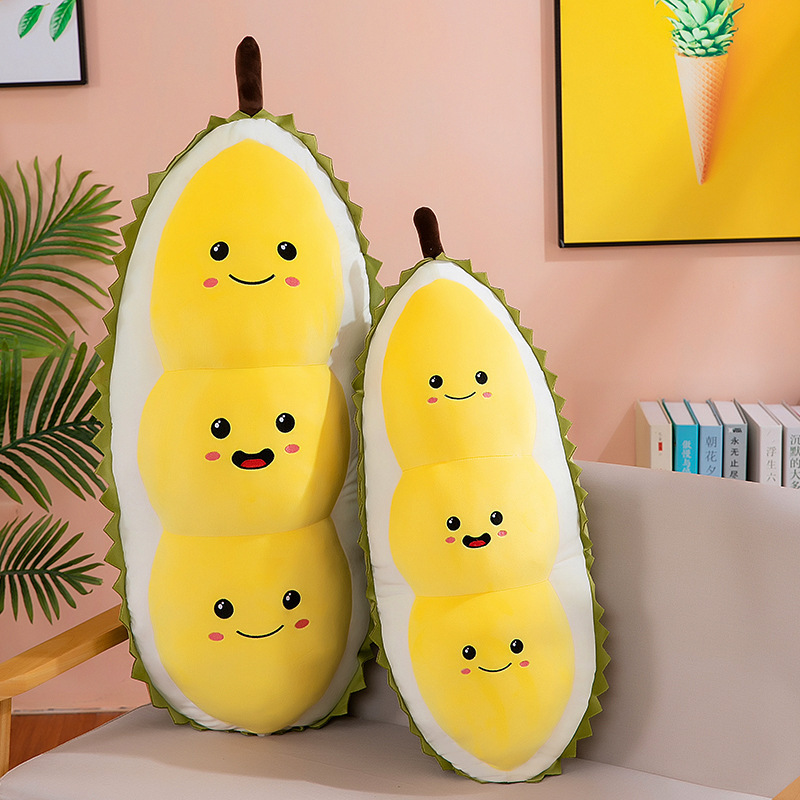 Cute durian plush pillow displayed upright on sofa in two sizes