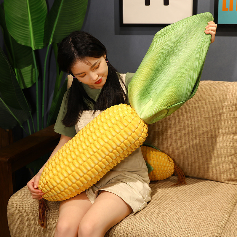 Corn plush pillow with peelable leaf design shown in use