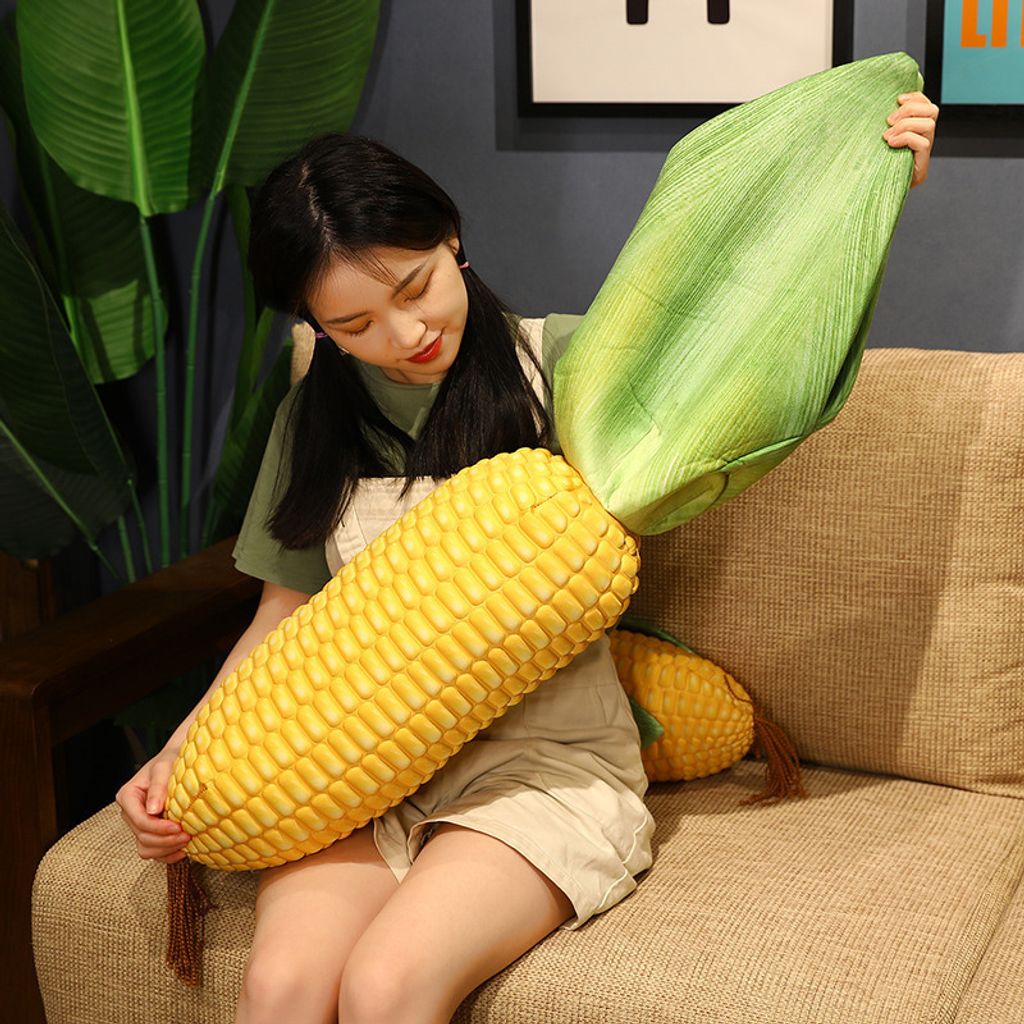 Corn plush pillow with peelable leaf design shown in use