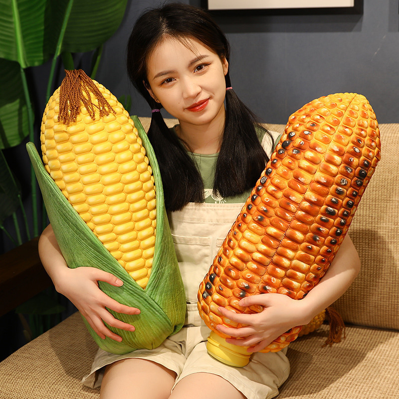 Corn plush pillow shown in leaf corn and roasted corn styles