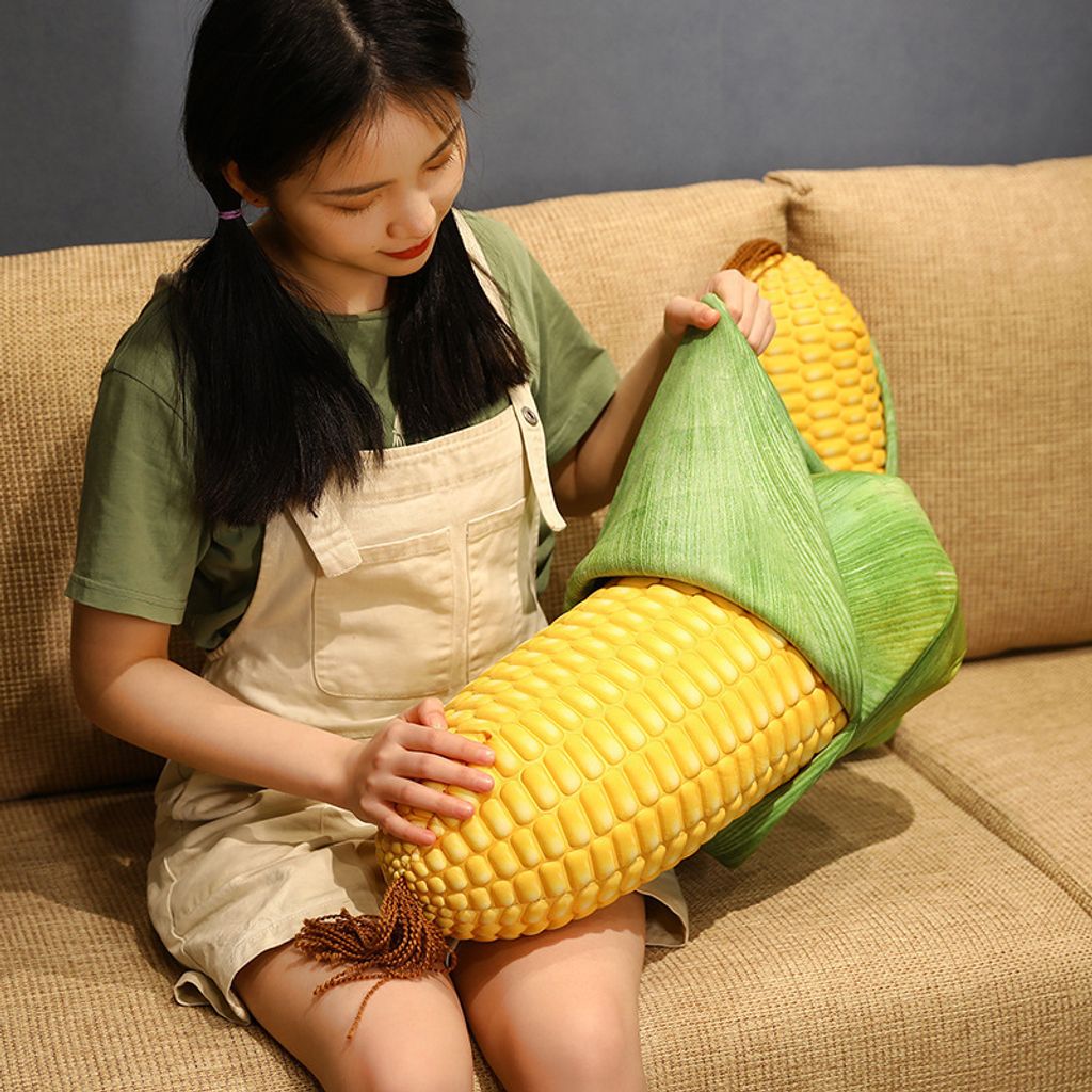 Corn plush pillow held on sofa showing realistic corn texture