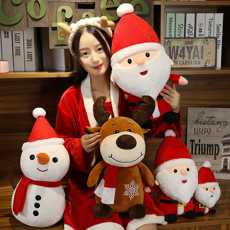 Cute Christmas plush toys including Santa Claus, Snowman, and Reindeer displayed together in a cozy setting