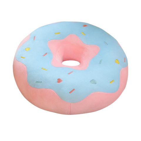 Donut plush pillow on white background