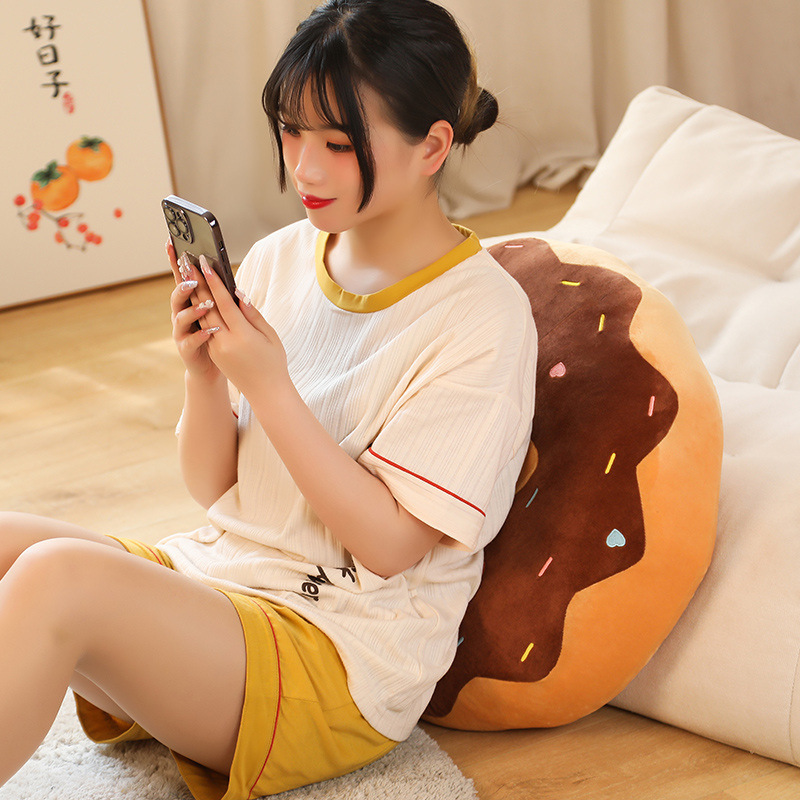 Donut plush pillow used as a cozy back cushion